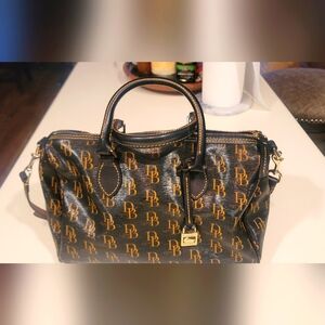 Dooney and Burke lightly used purse with red interior, shoulder strap removable.